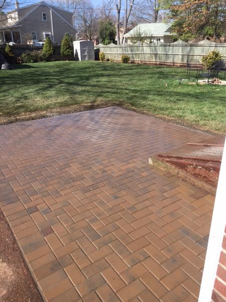 newly constructed red and brown pavers in a herringbone pattern